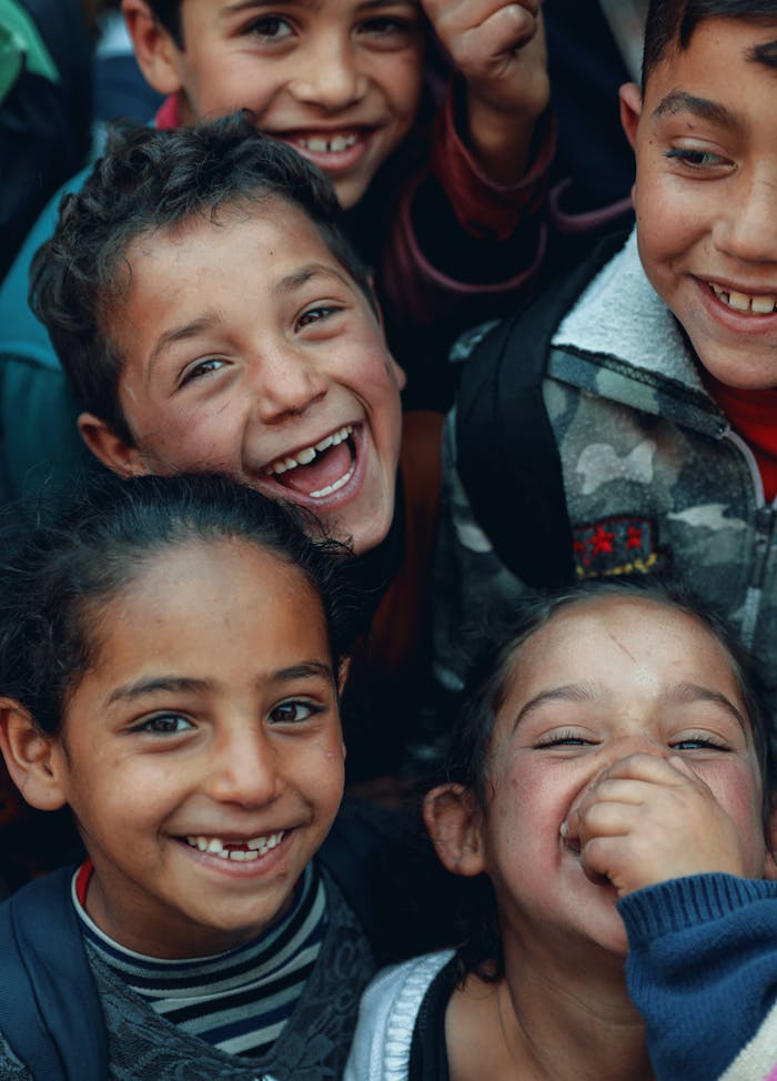 Happy children sharing laughter outdoors in Bqaa Kafra, Lebanon.